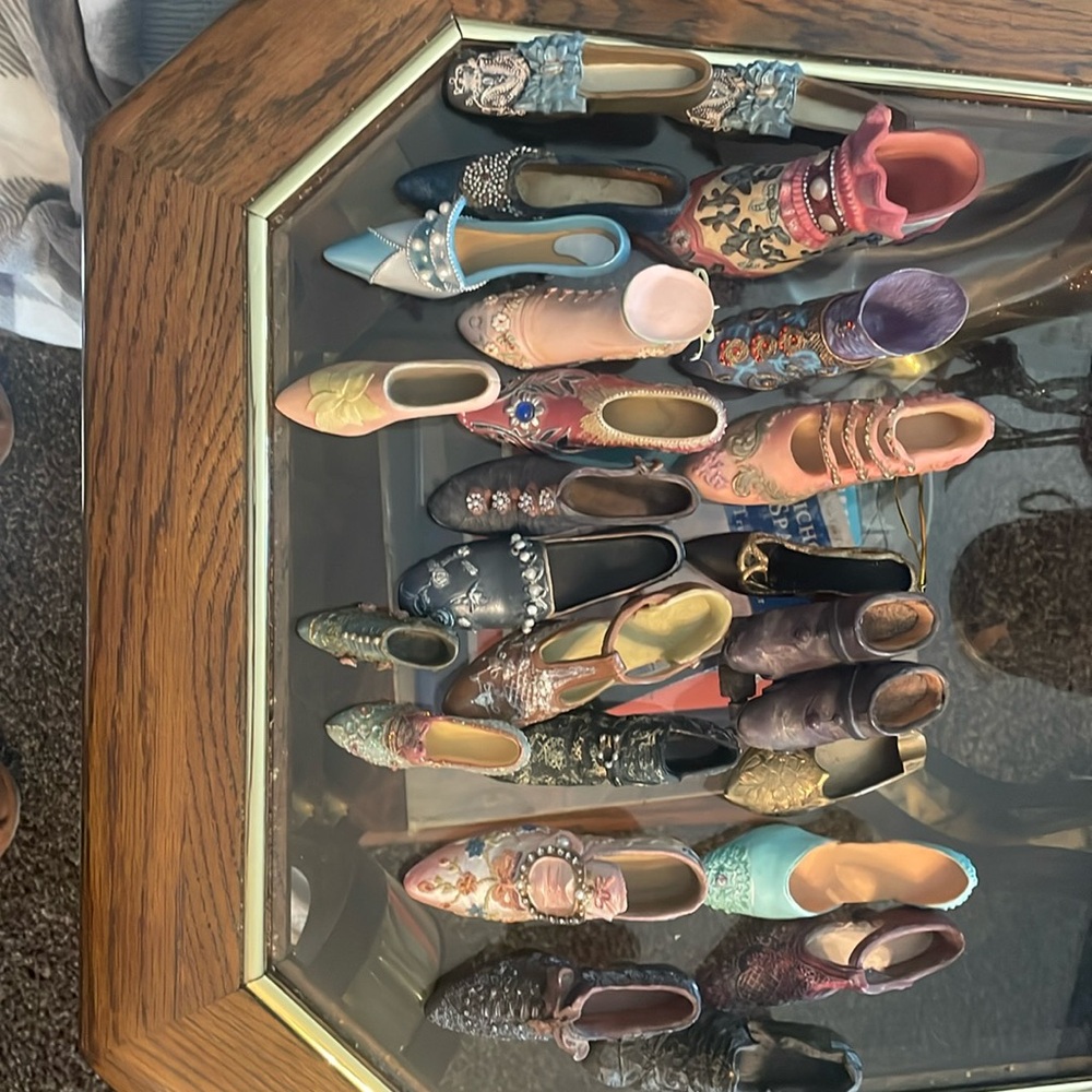 Antique miniature shoes with an antique miniature rollerskate ￼